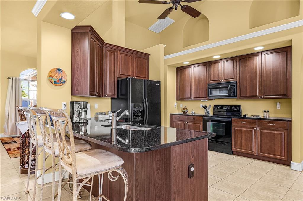 Kitchen featuring granite counters and counter seating.
