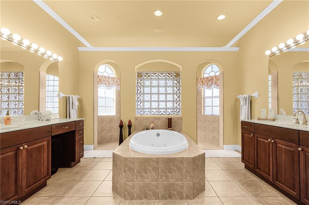 Primary Bathroom w/ jetted soaking tub, dual vanities and walk through shower