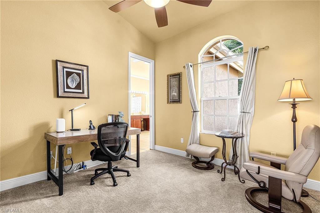 Carpeted office with desk and chair