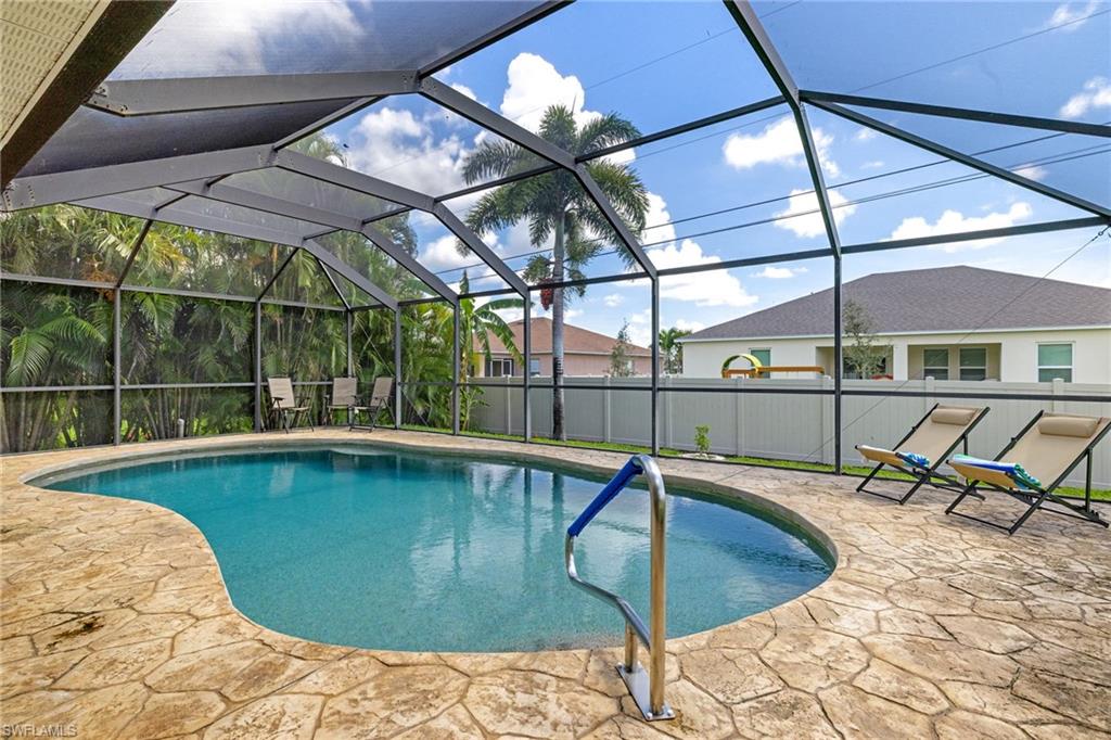 View of swimming pool with a patio and a lanai
