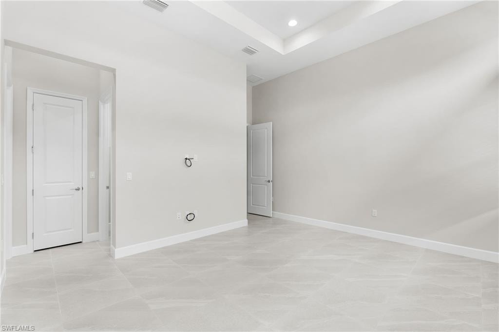 Primary suite with 2 walk-in closets, coffered ceiling, transom windows.