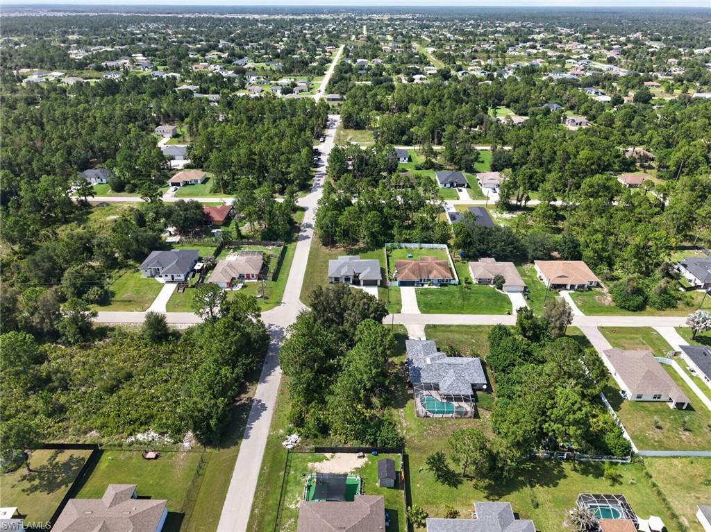 Aerial view of a residential neighborhood featuring paved streets and established homes