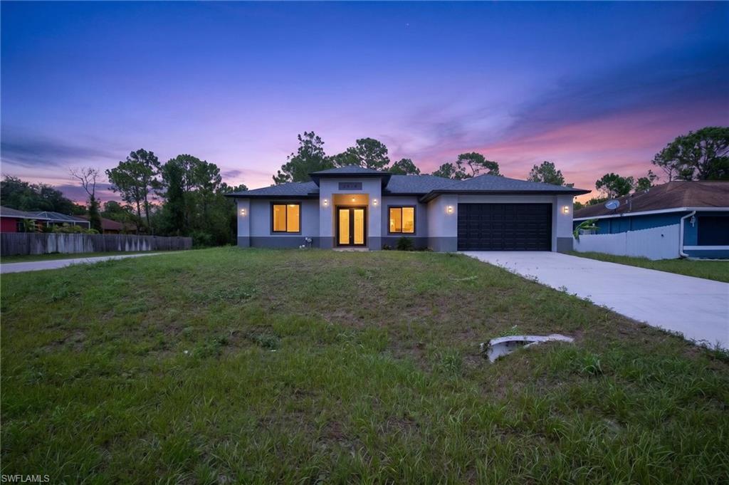 Contemporary-style residence featuring a two-tone stucco exterior