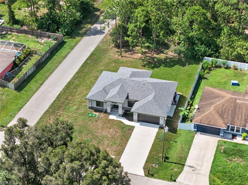 Modern single-story residence with a gray shingle roof and a light-colored stucco exterior