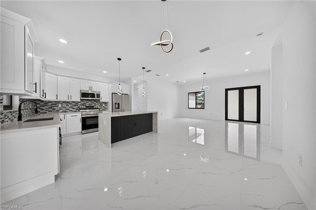 Open-concept living space with large format tile flooring throughout