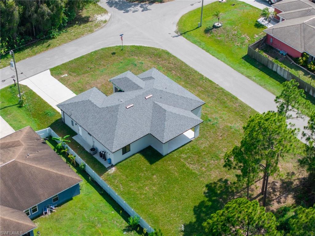 Newly constructed residence with a grey shingle roof and a paved driveway