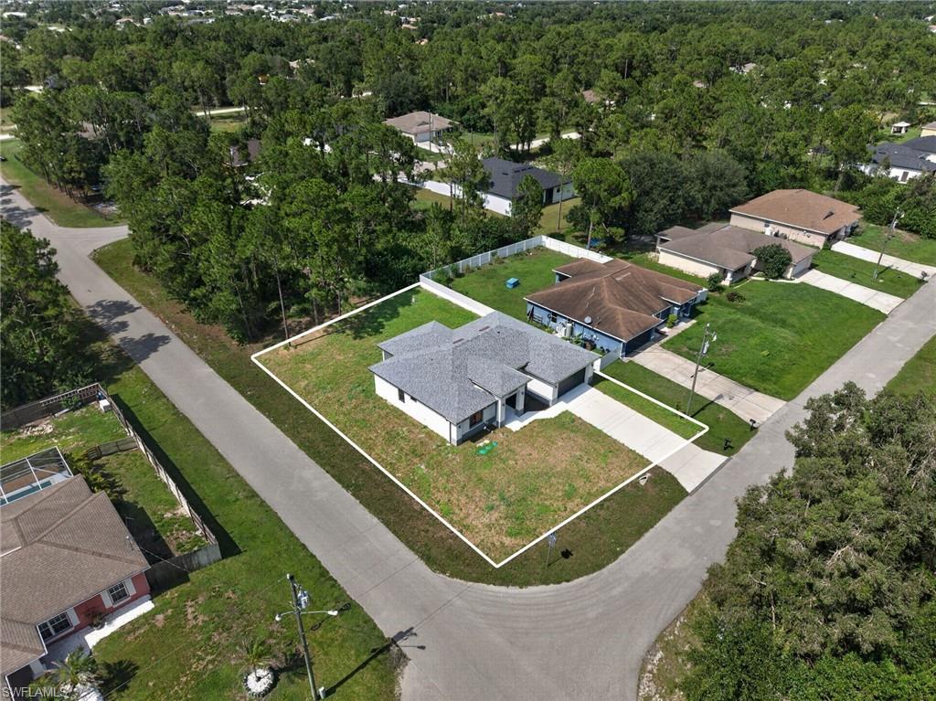 Newly constructed residence with a light gray shingle roof, white exterior siding, and an attached two-car garage