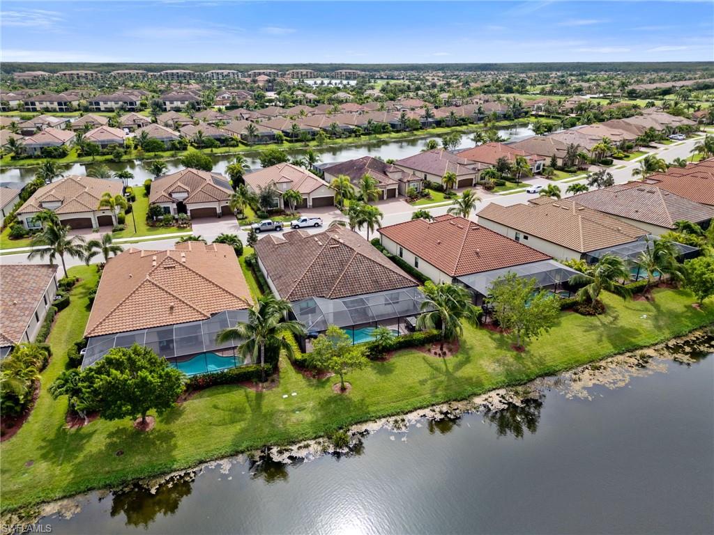 Aerial perspective showcasing a residential community with water frontage