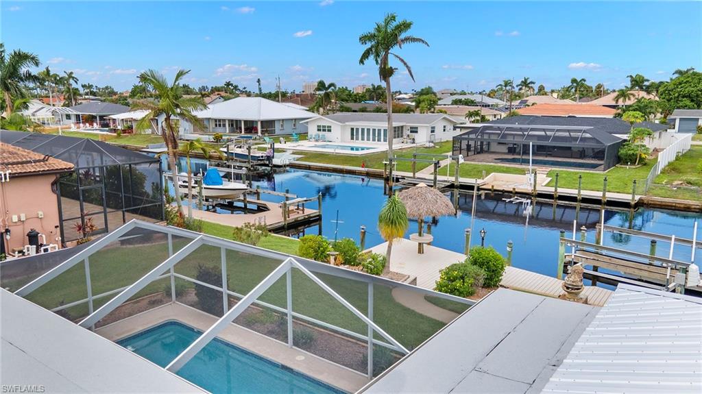 View of dock featuring a water view and a lanai