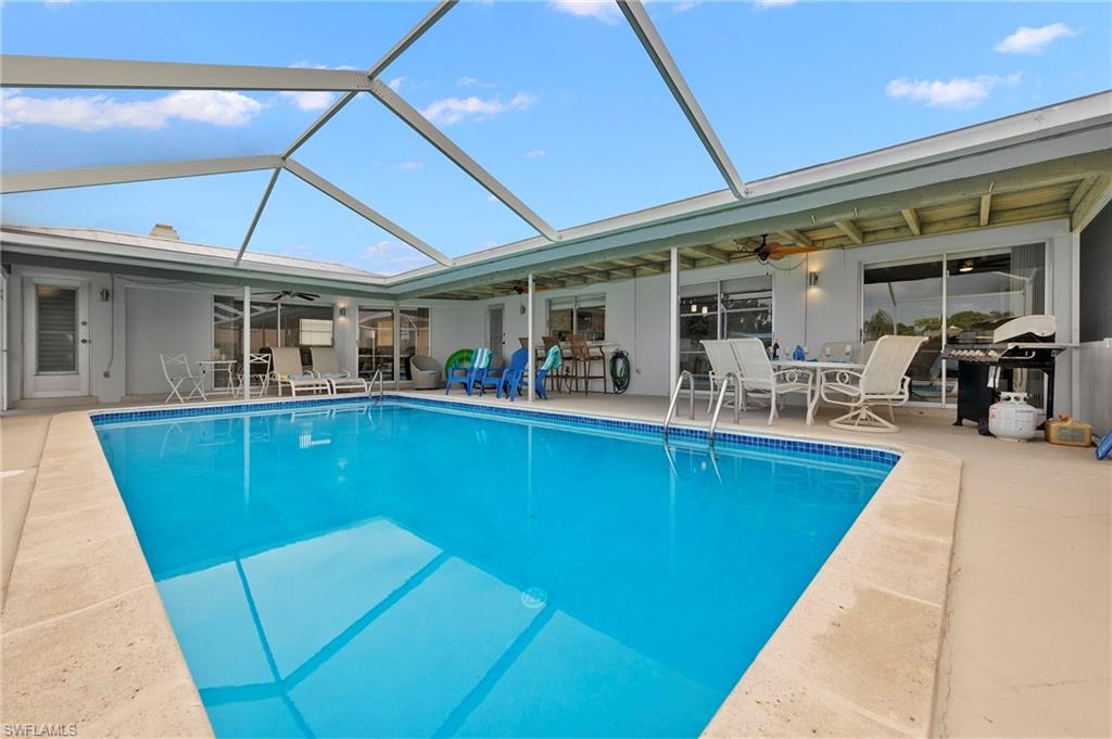 View of pool featuring ceiling fan, a lanai, and a patio area