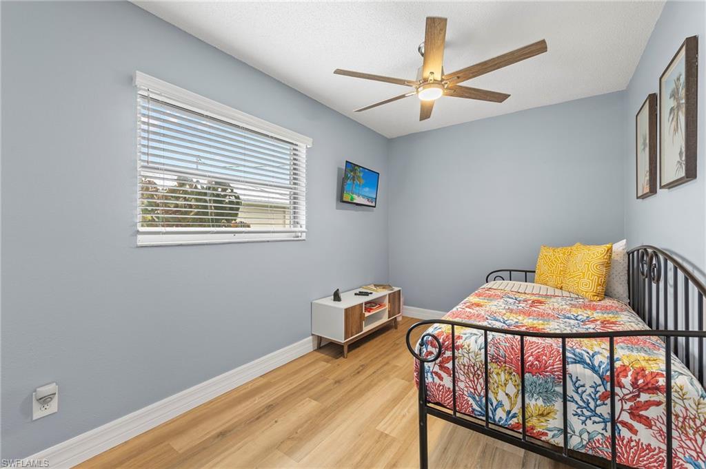 Bedroom featuring ceiling fan and light wood-type flooring