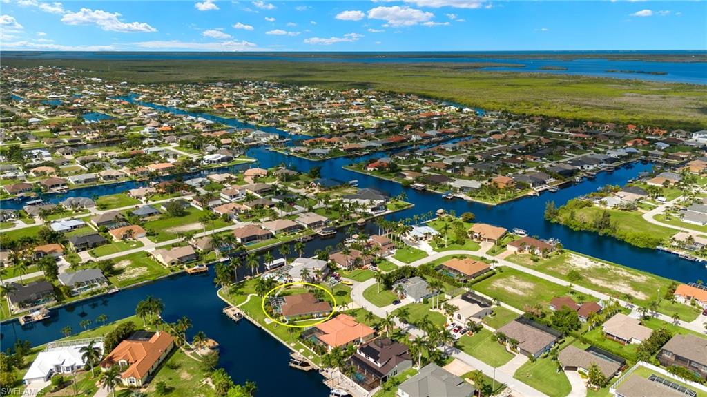 Birds eye view of property with a water view