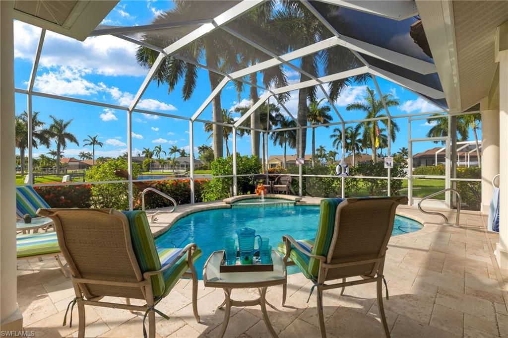 View of swimming pool with a patio area and a lanai