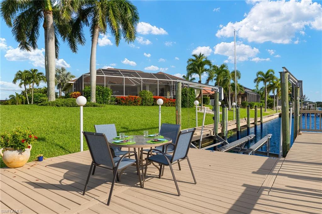 View of dock with a lawn