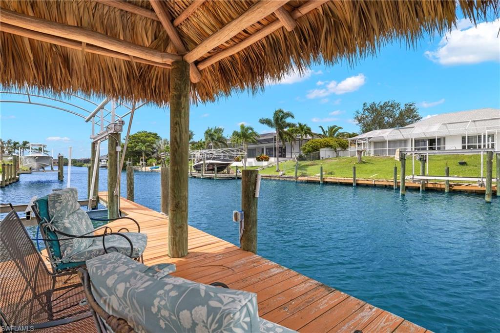 Dock area with a water view and boat lift