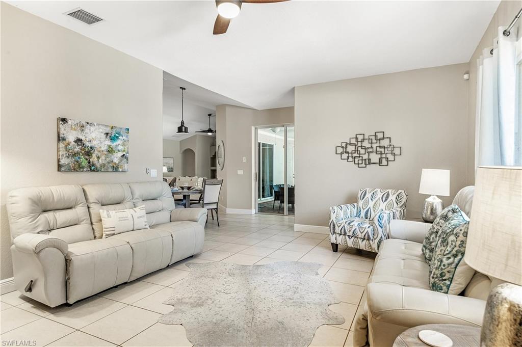 Living area featuring ceiling fan and light tile patterned floors