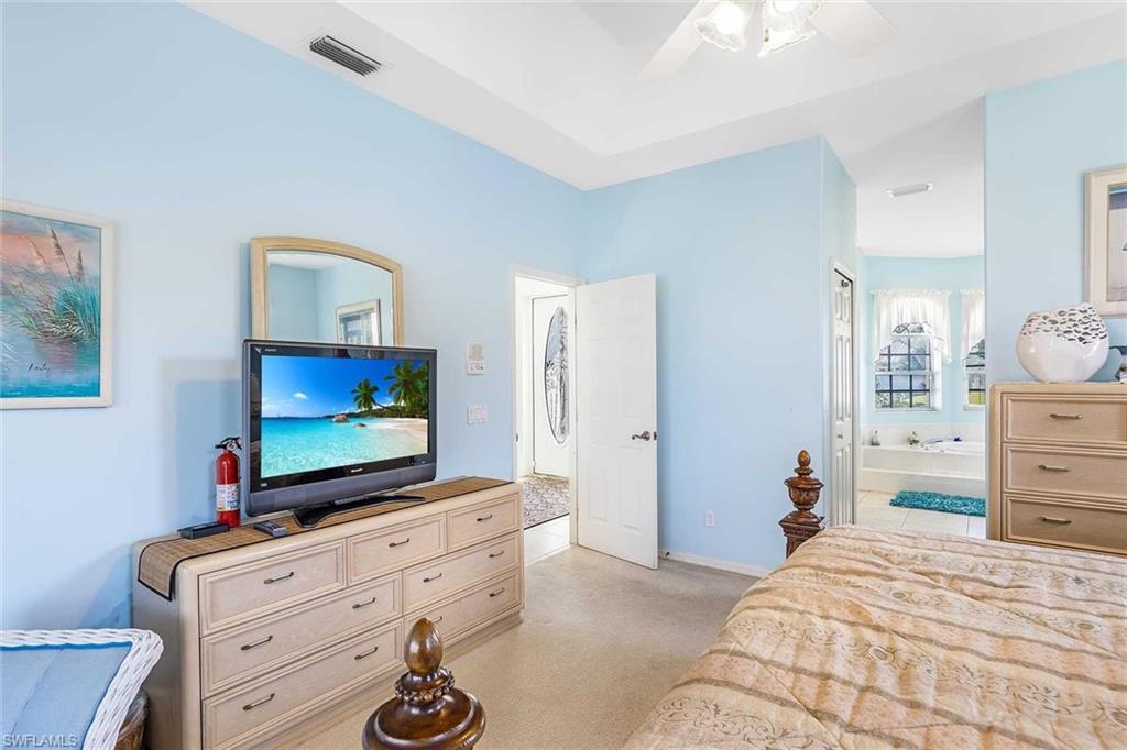 Primary Bedroom with Flat Screen tv and adjoining bathroom