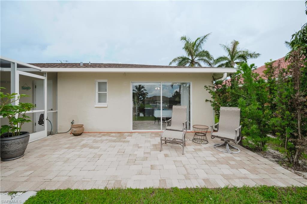 View of patio / terrace featuring a lanai