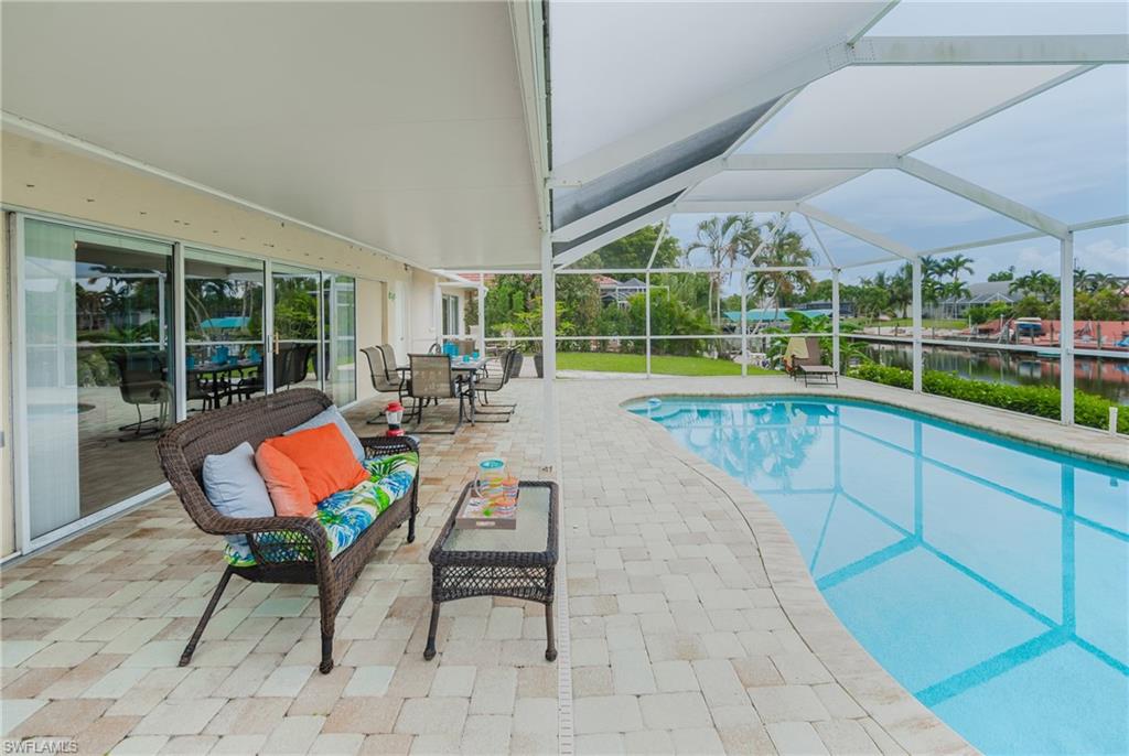 Screened lanai with pool and canal view