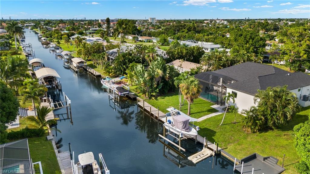 Birds eye view of property with a water view