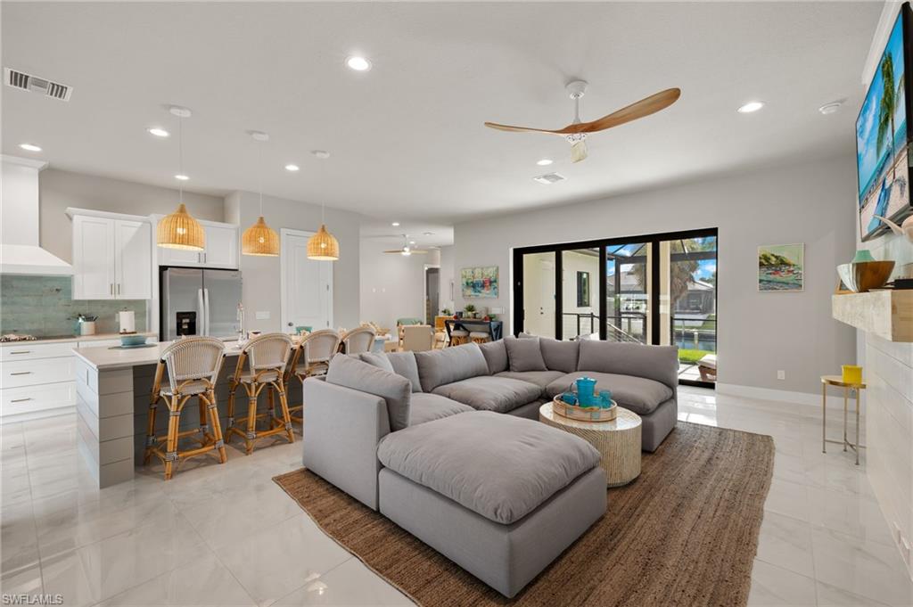 Living room with ceiling fan and a fireplace