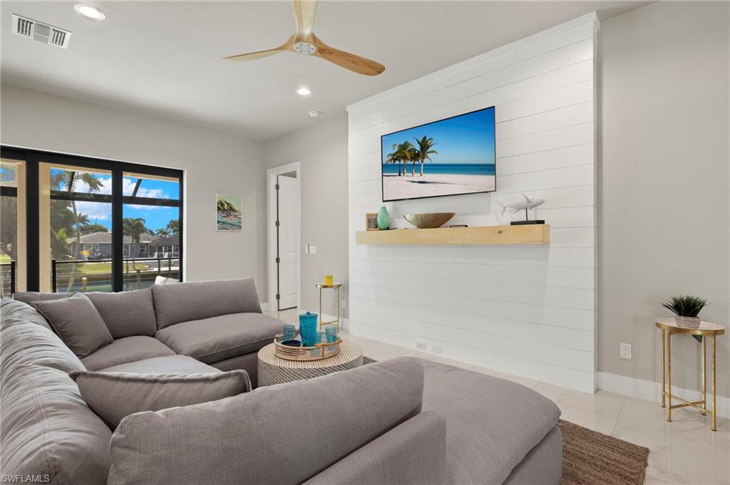 Tiled living room featuring ceiling fan