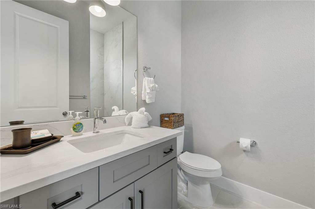 Bathroom with tile patterned floors, toilet, and vanity