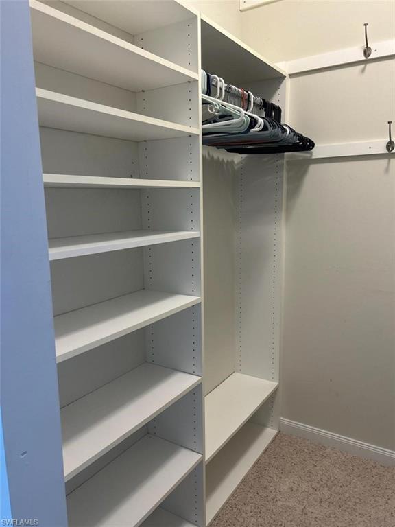 Primary bedroom walk in closet