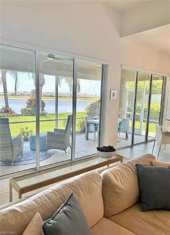 Spacious living room overlooking the large lanai with privacy walls and amazing views of the lake