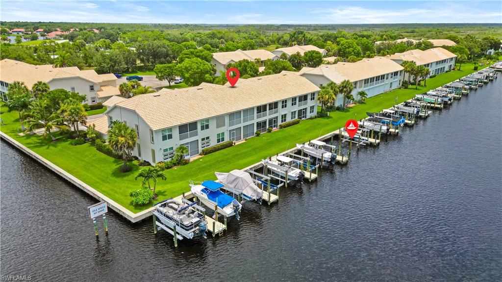 Waterfront complex with multiple boat slips featuring direct water access