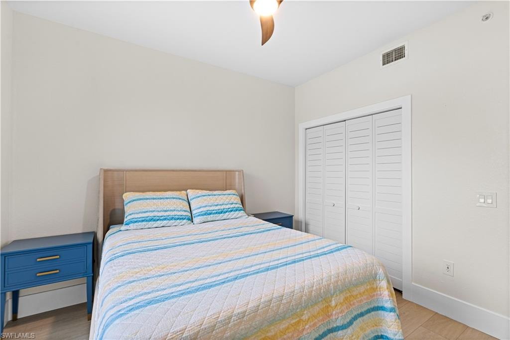 Bedroom featuring light-toned walls and wood-finish flooring