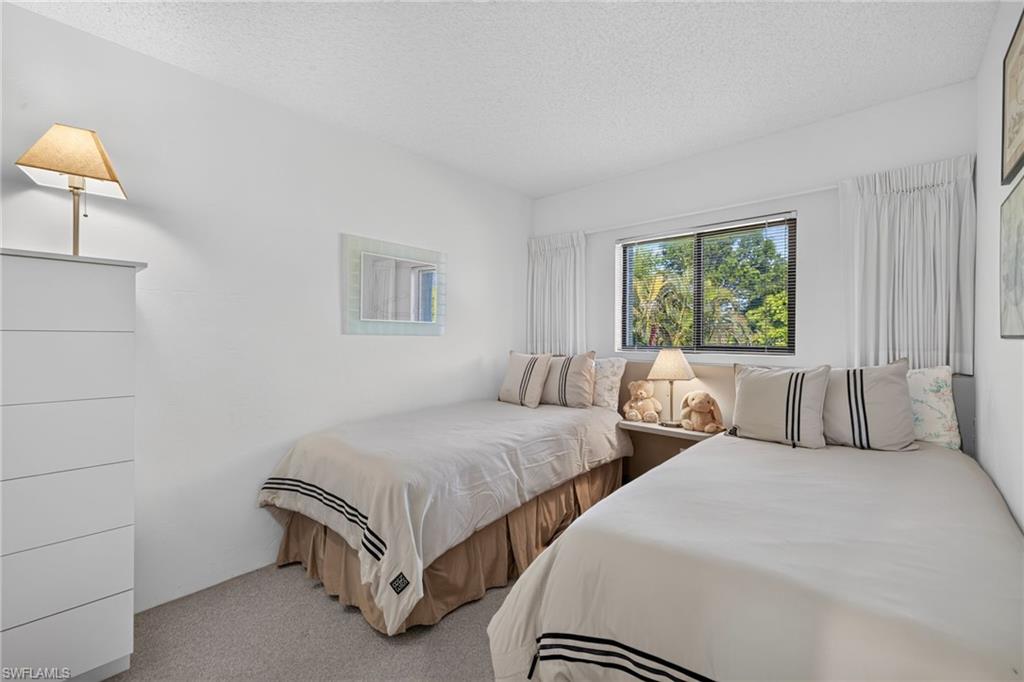 Bedroom featuring light-colored carpeting and white walls