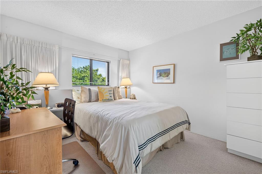 Primary Bedroom featuring a double-pane window, white textured walls