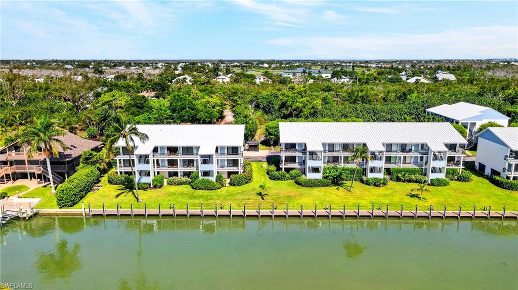 Waterfront multi-unit property featuring a metal roof and private balconies