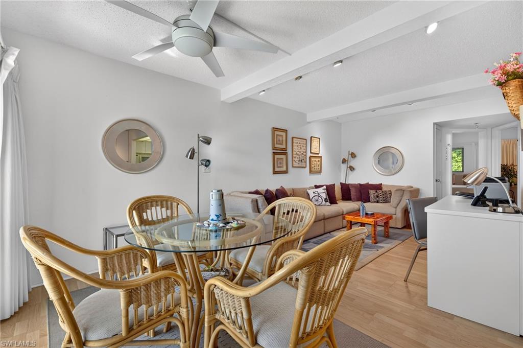 Open concept living space featuring wood-finish flooring, recessed lighting, and a ceiling fan