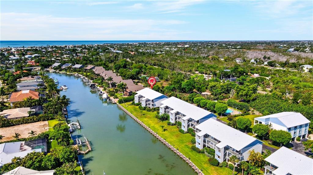 Waterfront community with canal access, mature landscaping, and multi-story residential buildings
