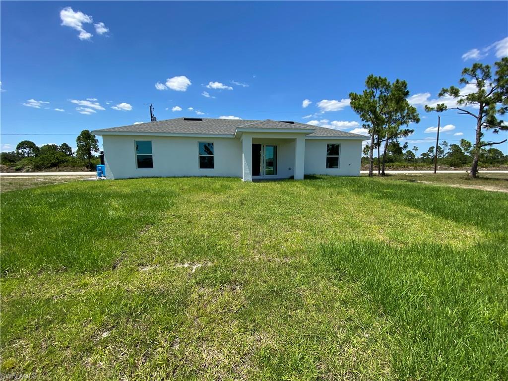 Rear view of house with a lawn