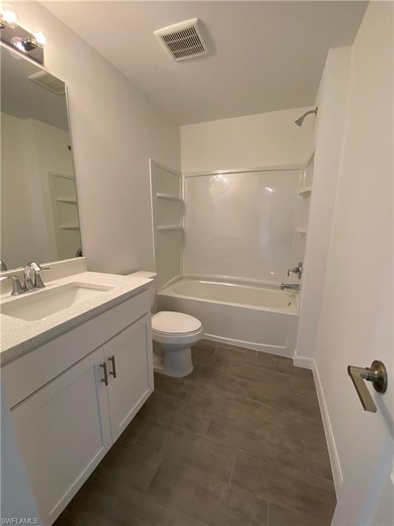 Full bathroom with washtub / shower combination, vanity, and toilet