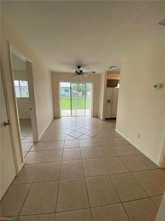 Dining area overlooks rear year with sliding glass door to patio