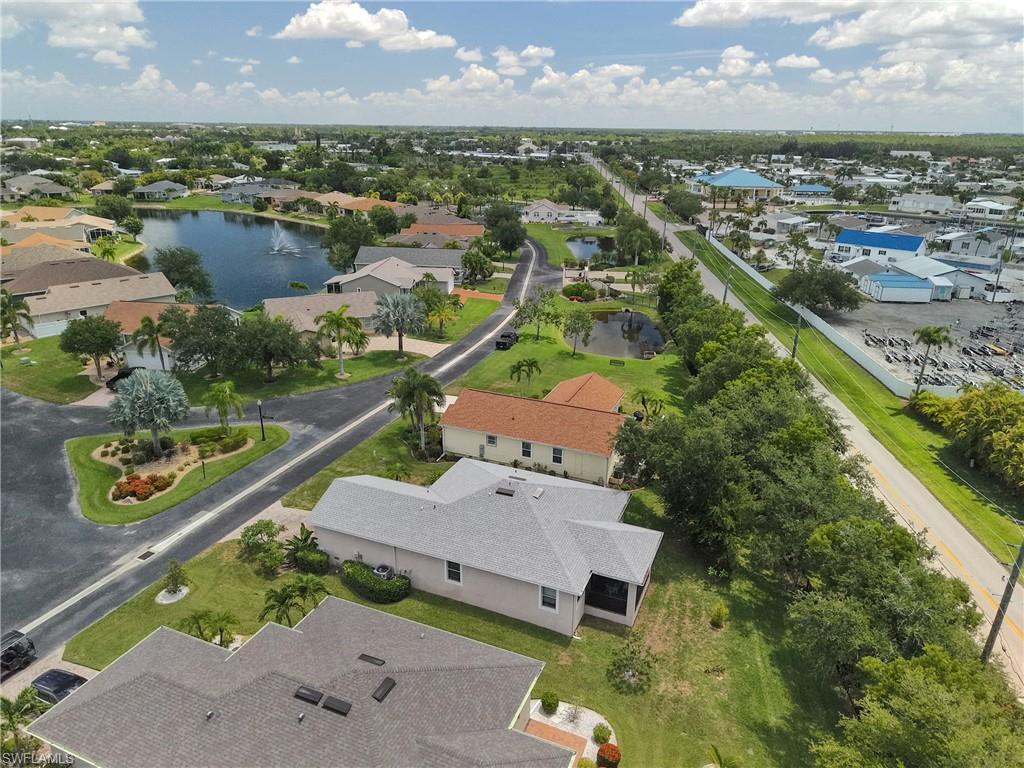 Aerial perspective showcasing the community layout with a central pond featuring a fountain