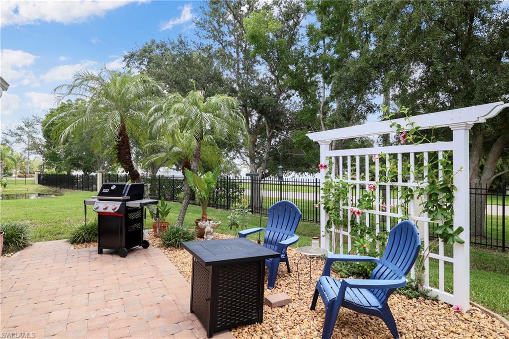 Paver patio with a white trellis feature, surrounded by gravel landscaping
