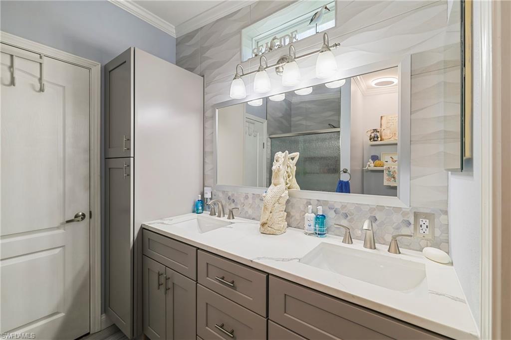 Dual vanity with integrated sinks, quartz countertop, and brushed nickel fixtures