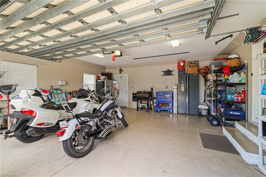 Spacious garage featuring light beige walls and a speckled epoxy floor