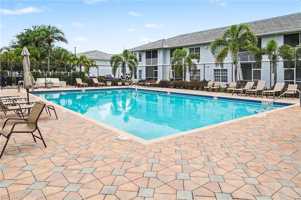 Outdoor swimming pool featuring a light blue interior finish and integrated steps