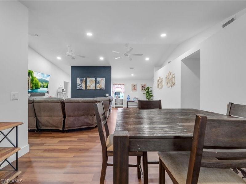 Spacious interior featuring wood-finish flooring, recessed lighting, and multiple ceiling fans