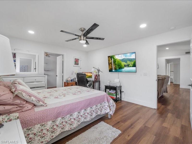 Bedroom featuring wood-finish flooring, recessed lighting, and a ceiling fan with light