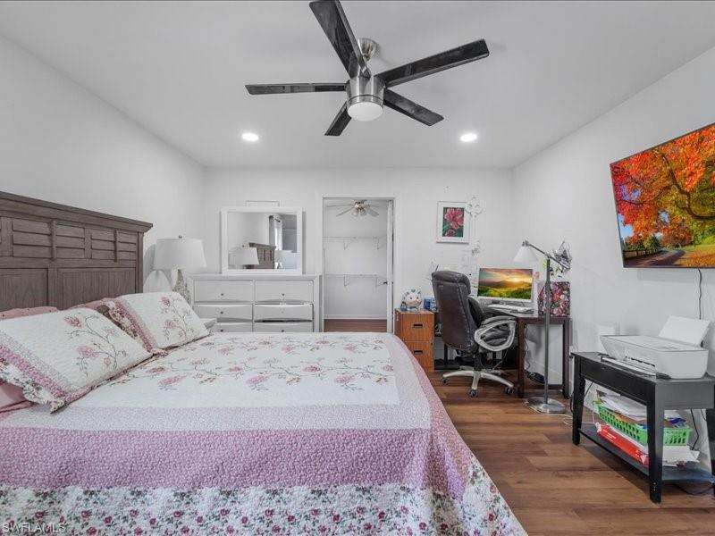 Bedroom featuring wood-finish flooring, recessed lighting, and a contemporary ceiling fan