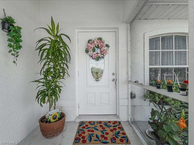 White paneled door with an oval-shaped decorative glass insert