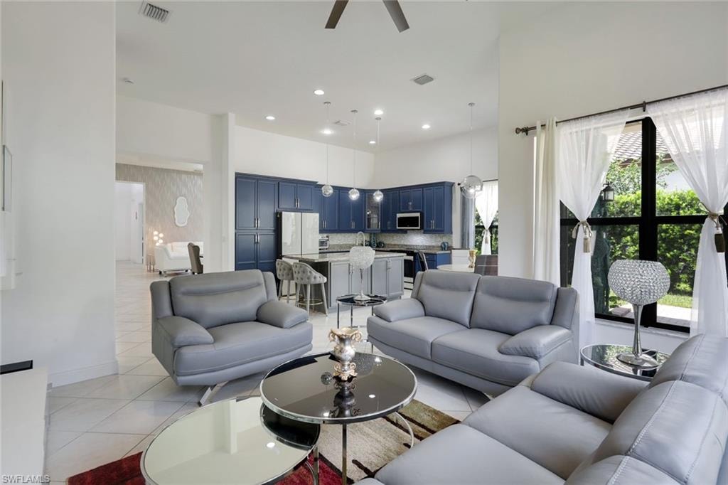 Open-concept living space featuring high ceilings, recessed lighting, and tile flooring
