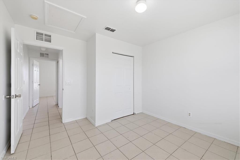 Neutral-toned tile flooring extends throughout this interior space